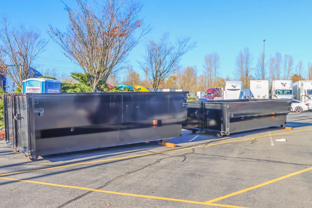 Professional dumpster rental service with roll-off container on residential driveway in Midland Park